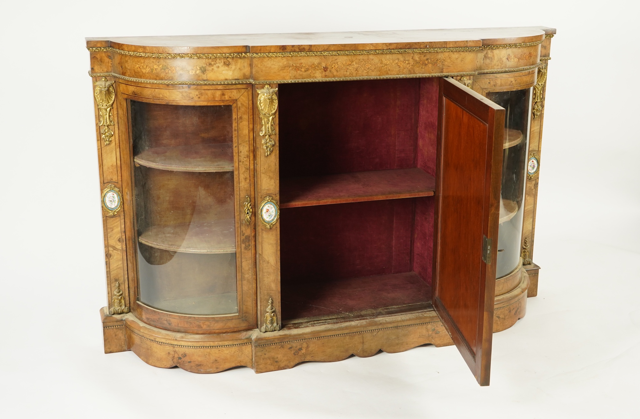 A Victorian marquetry inlaid, gilt metal mounted bowfront side cabinet